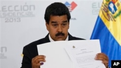 Venezuelan President Nicolas Maduro holds official certificate declaring him winner of presidential election, Electoral Council, Caracas, April 15, 2013.