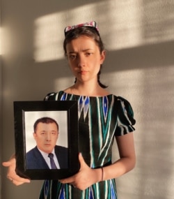 Aykanat Wahitjan holds a picture of her father, Wahitjan Osman, in Istanbul in April. (Photo courtesy of Aykanat Wahitjan)