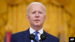 President Joe Biden speaks during an event to mark International Women's Day, Monday, March 8, 2021, in the East Room of the White House in Washington. (AP Photo/Patrick Semansky)