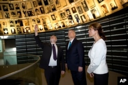 Hungarian Prime Minister Viktor Orban, center, and his wife, Aniko Levai, visit the Hall of Names at the Yad Vashem Holocaust Memorial in Jerusalem, July 19, 2018.
