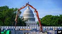FILE - A concrete pump frames the Capitol Dome during renovations and repairs to Lower Senate Park on Capitol Hill in Washington, May 18, 2021. Senators on Wednesday reached rare bipartisan preliminary agreement on a massive infrastructure bill.