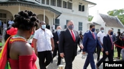 Suriname's President Chan Santokhi and U.S. Secretary of State Mike Pompeo walk together, in Paramaribo, Suriname, Sept. 17, 2020.