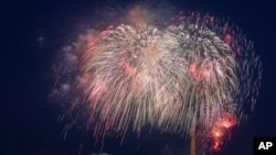 FILE - Fourth of July fireworks explode over the Lincoln Memorial, the Washington Monument and the U.S. Capitol along the National Mall in Washington, July 4, 2020.