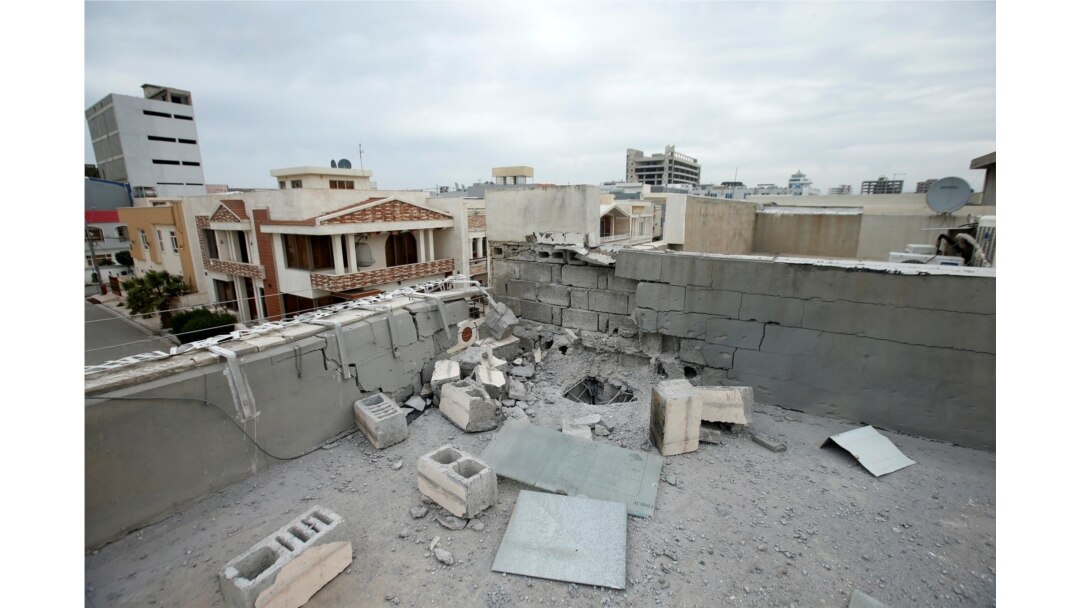 A damaged roof is seen after a barrage of rockets hit in and near Irbil International Airport, in Irbil, Iraq, Feb. 16, 2021.
