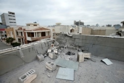 A damaged roof is seen after a barrage of rockets hit in and near Irbil International Airport, in Irbil, Iraq, Feb. 16, 2021.