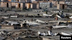 This general view shows debris and shelters the day after a fire destroyed large swathes of the Grande-Synthe migrant camp near Dunkirk in northern France, April 11, 2017.