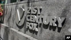 FILE - The 21st Century Fox sign is seen outside of the News Corporation headquarters building in New York.