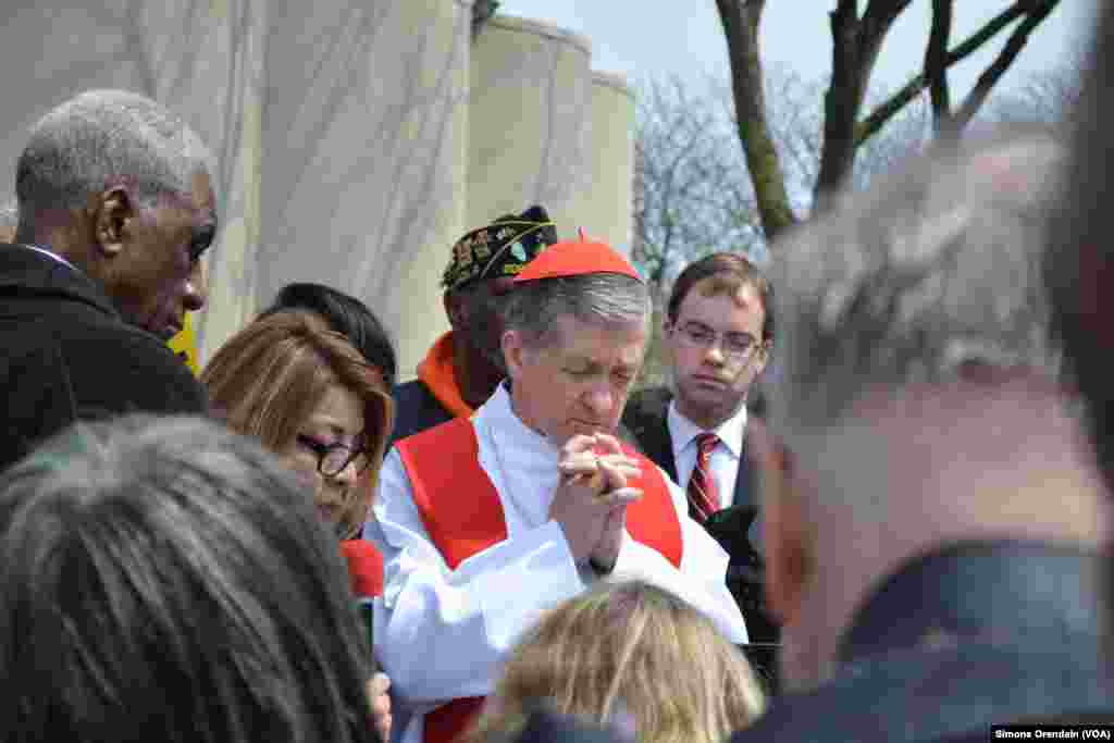 Cardinal Blase Cupich of the Roman Catholic Archdiocese of Chicago prays as names of homicide victims are read during a prayer walk through Chicago's Englewood neighborhood on the city's South Side, April 14, 2017. 