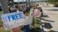 FILE - Protesters hold signs in support of Alan Gross, the U.S. contractor jailed in Cuba for crimes against the state, at a rally for his release in West Palm Beach, Florida, Nov. 11, 2012. 