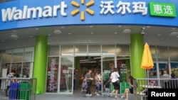 FILE - Shoppers are seen at a store of global retail giant Walmart in Shenzhen, Guangdong province, China, April 4, 2018.