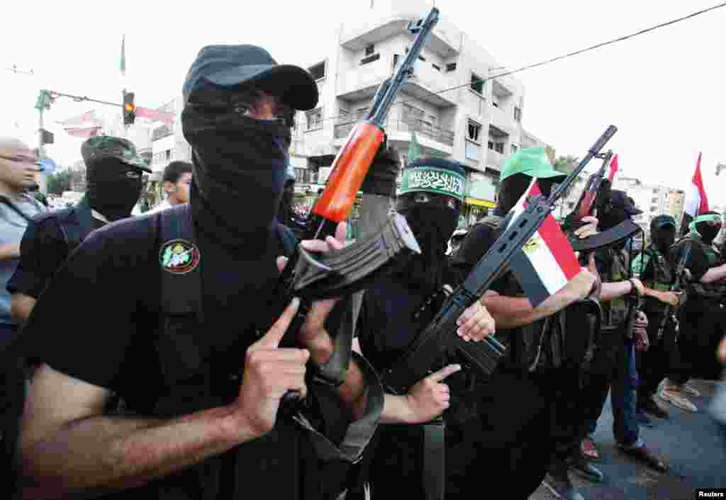 Hamas militants celebrate in the streets in Gaza City after Islamist Mohamed Morsi of the Muslim Brotherhood was declared Egypt&#39;s first democratic president, June 24, 2012. (Reuters)