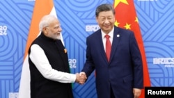 Chinese President Xi Jinping and India Prime Minister Narendra Modi meet on the sidelines of the BRICS summit in Kazan, Russia Oct. 23, 2024. 