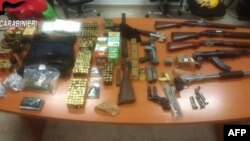 An image grabbed from a video handout by the press office of the Italian Carabinieri Police Forces on Dec. 19, 2019 shows some of the weapons and ammunitions seized as part of a swoop against the southern 'Ndrangheta organized crime syndicate.