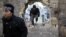 Free Syria Army fighters move through a hole in a wall during a fight with forces loyal to President Bashar al Assad at the front line in Aleppo December 24, 2012.