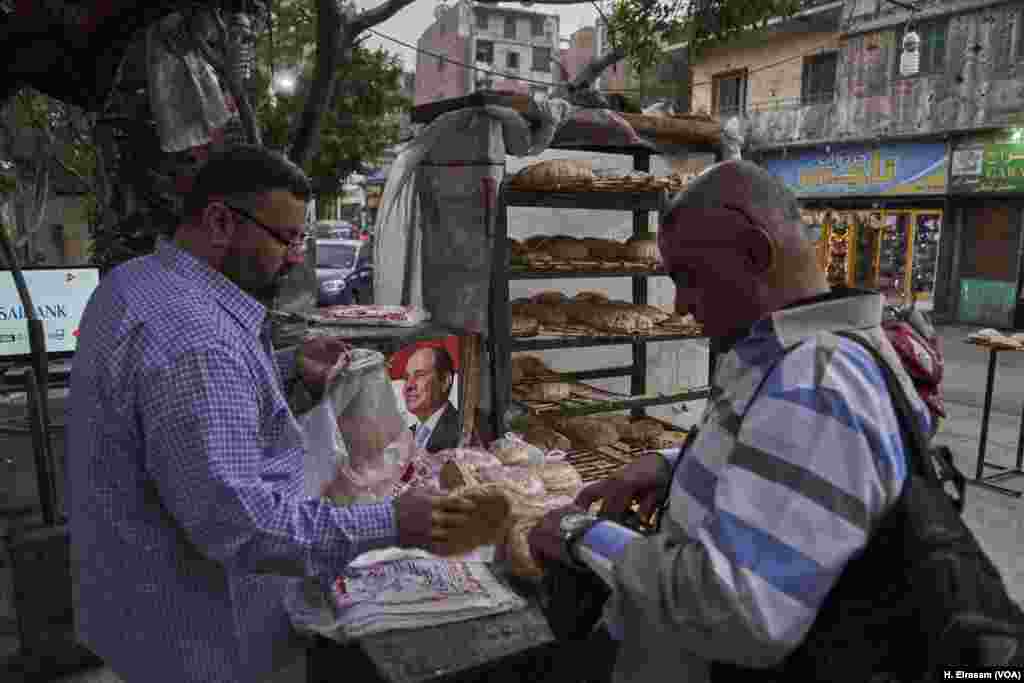 Bread vendor keeps President Abdel Fattah el-Sissi&rsquo;s campaign flyer on his counter in central Cairo. With Egypt&#39;s economic growth expected surpass a whopping 5 percent this year, el-Sissi sailed to victory uncontested in this year&rsquo;s election with many voters crediting him with improving an economy compared to the one he inherited in 2014.