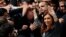 Former Argentine President Cristina Fernandez de Kirchner waves to supporters as she leaves a Justice building where she attended court to answer questions over a probe into the sale of U.S. dollar futures contracts at below-market rates by the central bank during her administration, in Buenos Aires, April 13, 2016.