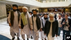 FILE: In this file photo taken on May 28, 2019, Mullah Abdul Ghani Baradar, the Taliban group's top political leader, third from left, arrives with other members of the Taliban delegation for talks in Moscow, Russia.