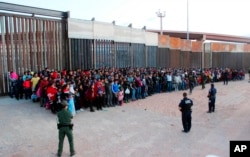 FILE - The U.S. Customs and Border Protection shows some of 1,036 migrants who crossed the U.S.-Mexico border in El Paso, Texas, the largest that the Border Patrol says it has ever encountered, May 29, 2019. The federal government is opening a new mass sh