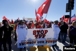 Protesters line one side of a roadway leading to Sunnylands where U.S. President Barack Obama prepares to host leaders from Southeast Asia at the ASEAN Summit in Rancho Mirage, California, Feb. 15, 2016.