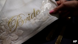 A detail of a napkin with the word 'Bride' embroidered in gold is on display at the Wedding Gallery, in London, March 28, 2018. 
