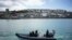 FILE - police officers patrol the harbour in St. Ives, Cornwall, England ahead of the G7 summit that takes place in nearby Carbis Bay.