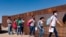 A group of Brazilian migrants walk around a gap in the U.S.-Mexico border in Yuma, Ariz., seeking asylum in the United States after crossing over from Mexico, June 8, 2021.