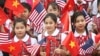 Vietnamese students hold U.S. and Vietnamese flags at a welcoming ceremony for U.S. President Barack Obama at the Presidential Palace in Hanoi, Vietnam, May 23, 2016.