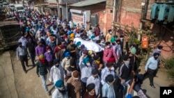 Sikh community members carry the body of slain Satinder Kaur, a government school teacher, during her funeral procession in Srinagar, India, Oct. 8, 2021.