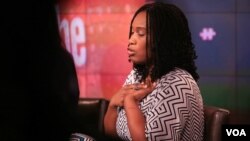 Morenike Giwa Onaiwu of the Autism Women’s Network clasps a "stimming" device while on the panel.