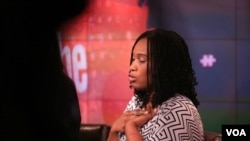 Morenike Giwa Onaiwu of the Autism Women’s Network clasps a "stimming" device while on the panel. (B. Workinger/VOA)