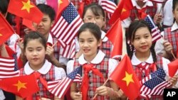 Vietnamese students hold U.S. and Vietnamese flags at a welcoming ceremony for U.S. President Barack Obama at the Presidential Palace in Hanoi, Vietnam, May 23, 2016.