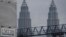 FILE - A 1MDB (1 Malaysia Development Berhad) logo is set against the Petronas Twin Towers at the flagship development site, Tun Razak Exchange in Kuala Lumpur, Malaysia.