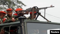 FILE - Military police officers ride on a truck as they patrol the streets of Kinshasa, Democratic Republic of Congo, June 29, 2017. 