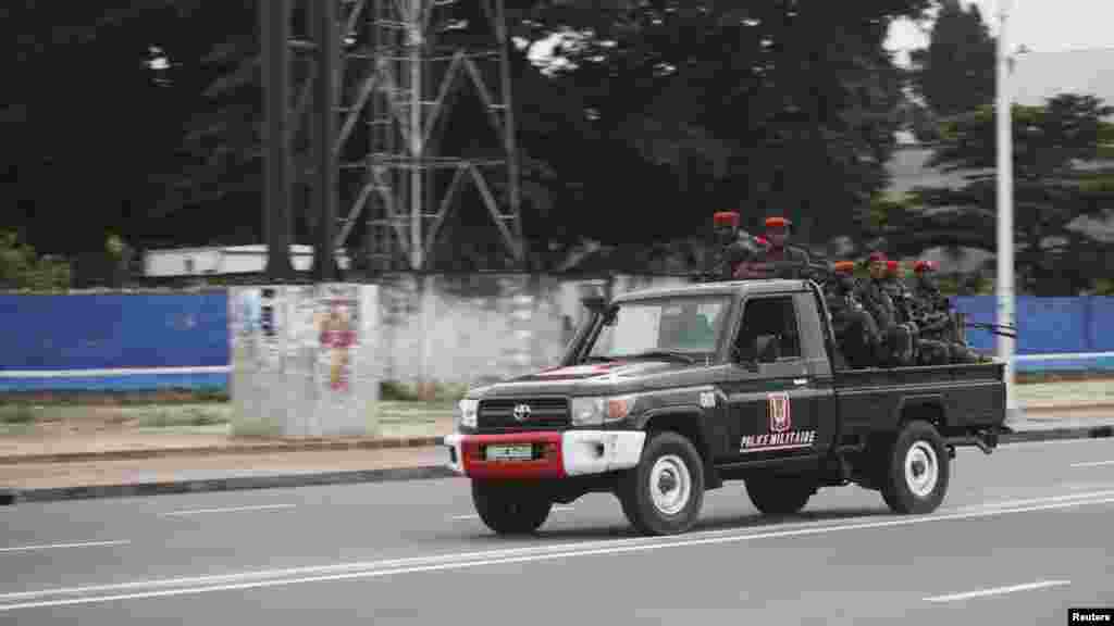 Congolese soldiers ride on their pick-up truck towards the state television headquarters in Kinshasa, Dec. 30, 2013.