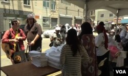 Skid Row residents go through the line, bagging basic necessities such as clothing, towels and soap.