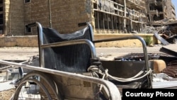 FILE: This picture taken in May 2014 shows a wheelchair that was left intact after the destruction of an Aleppo hospital.