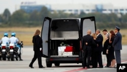 Family members mourn by a coffin with the remains of Cpl. Patrik Stepanek during a ceremony at the Prague's Vaclav Havel Airport, Czech Republic, Aug. 8, 2018. Stepanek was one of three Czech soldiers killed while on a foot patrol as part of NATO forces in eastern Afghanistan Sunday.