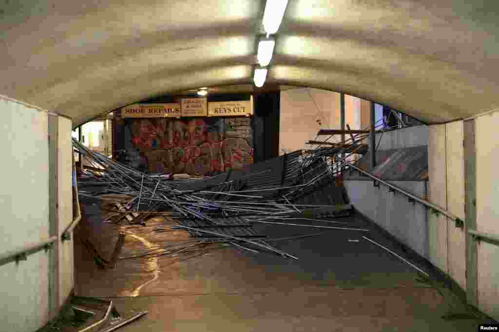 The roof of a pedestrian bridge that collapsed during strong winds is seen outside London Bridge Station in London, Oct. 28, 2013. 