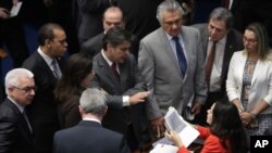 Lawyer Janaina Paschoal, sitting, talks with senators who support the impeachment of suspended President Dilma Rousseff, during the impeachment trial in Brasilia, Brazil, Aug. 26, 2016. 