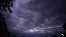 Lightning streaks across the sky in Tyler, Texas as a powerful line of thunderstorms moved across Texas, April 3, 2012. (AP)