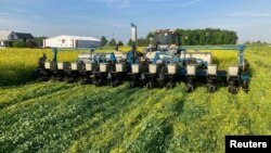 FILE - Farmer Dave Gruenbaum plants corn as he terminates off-season cover crops with a roller near Plain City, Ohio, May 2021. (Dave Gruenbaum/Handout via Reuters)