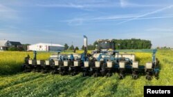 FILE - Farmer Dave Gruenbaum plants corn as he terminates off-season cover crops with a roller near Plain City, Ohio, May 2021. (Dave Gruenbaum/Handout via Reuters)