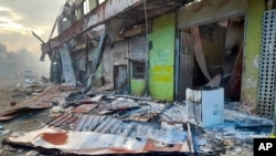 Debris lies on the street outside damaged shops in Chinatown, Honiara, Solomon Islands, Nov. 26, 2021.