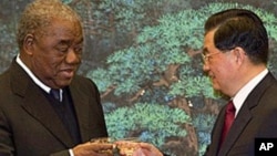 FILE - Zambian President Rupiah Banda, left, toasts with Chinese President Hu Jintao after a signing ceremony for a wide range of mining, trade and cultural agreements, at the Great Hall of the People in Beijing, China, Feb. 25, 2010.