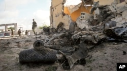 A Somali soldier observes the scene of a car bomb attack in the capital Mogadishu, Somalia, June 21, 2015. 