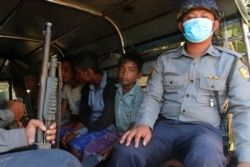 FILE - Rohingya Muslims detained by Myanmar immigration authorities are transferred into vehicles after arriving by boat at Thande village outside Yangon, Myanmar Nov. 16, 2018.