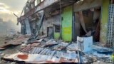 Debris lies on the street outside damaged shops in Chinatown, Honiara, Solomon Islands, Nov. 26, 2021.