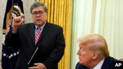 FILE - President Donald Trump listens as Attorney General William Barr speaks before President Donald Trump signs an executive order in the Oval Office of the White House, May 28, 2020.