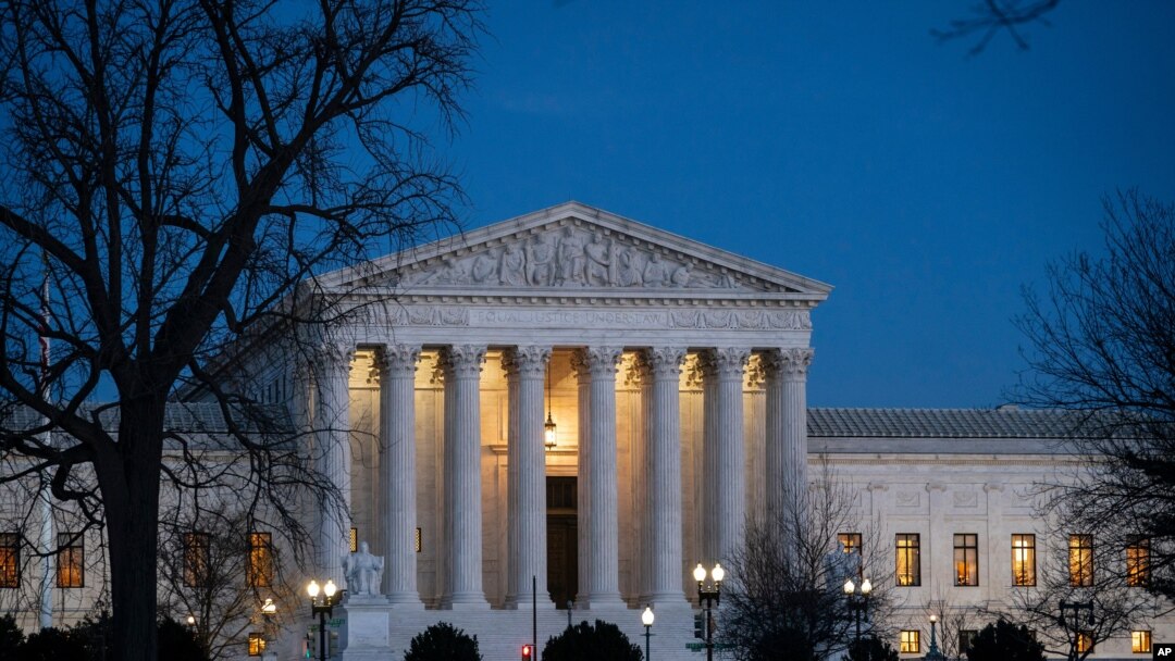 FILE - Night falls on the Supreme Court in Washington.