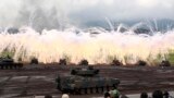 A line of Japan Ground Self-Defense Force tanks flare up a smoke screen during an annual live firing exercise at Higashi Fuji training range in Gotemba, southwest of Tokyo.
